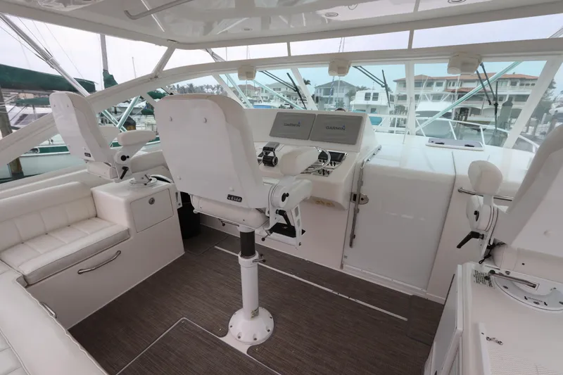 Slide: The Image of 2007 Cabo 40 Hardtop Express helm with white seating and modern controls. - 21
