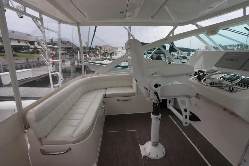 Slide: The Image of 2007 Cabo 40 Hardtop Express yacht interior with white seating and helm station. - 22