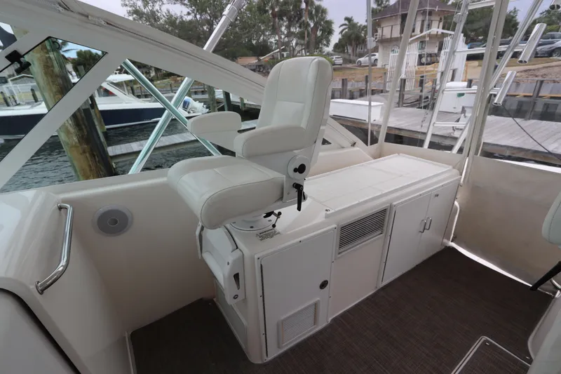 Slide: The Image of 2007 Cabo 40 Hardtop Express helm with white captain's chair and control panel. - 23