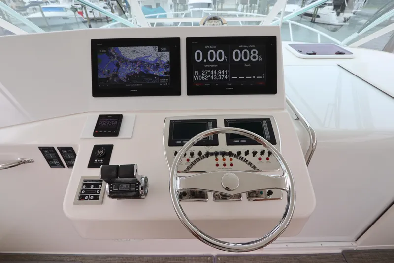 Slide: The Image of Helm of 2007 Cabo 40 Hardtop Express with navigation screens and controls. - 29