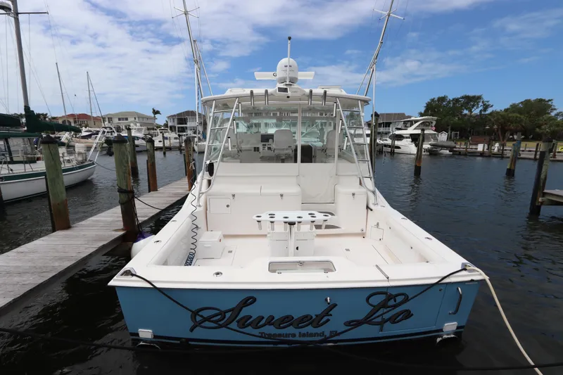 Slide: The Image of 2007 Cabo 40 Hardtop Express boat docked at marina, rear view. - 3