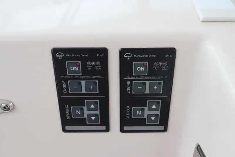Slide: The Image of Control panel of 2007 Cabo 40 Hardtop Express with MAN Marine Diesel engine controls. - 31