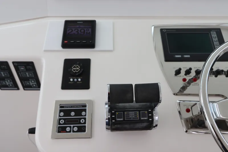 Slide: The Image of Control panel of a 2007 Cabo 40 Hardtop Express boat with various instruments and steering wheel. - 32