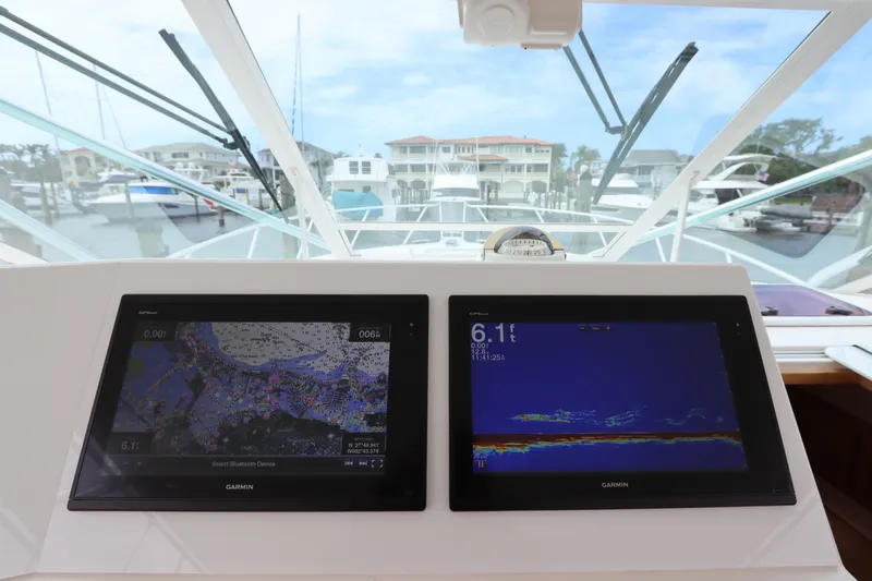 Slide: The Image of Helm of 2007 Cabo 40 Hardtop Express with dual Garmin navigation displays. - 34