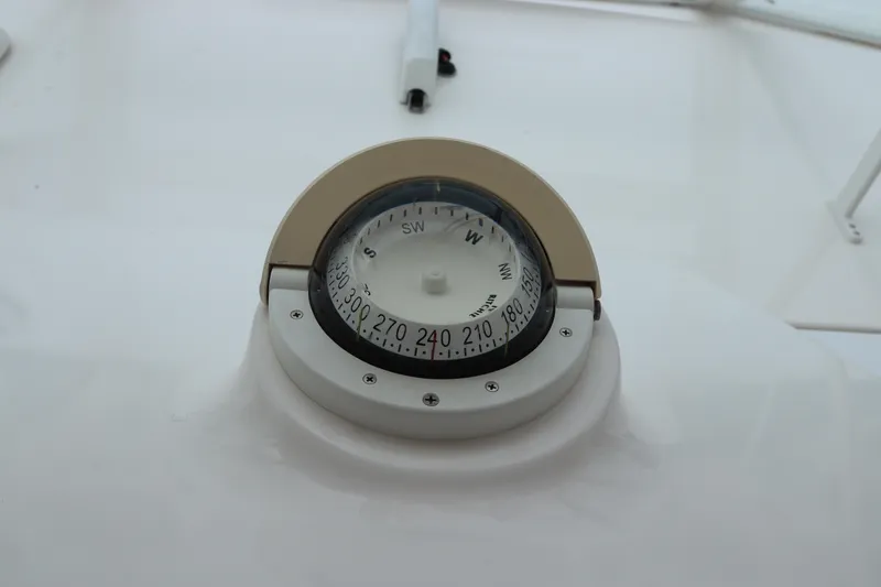 Slide: The Image of Compass on 2007 Cabo 40 Hardtop Express boat dashboard. - 35
