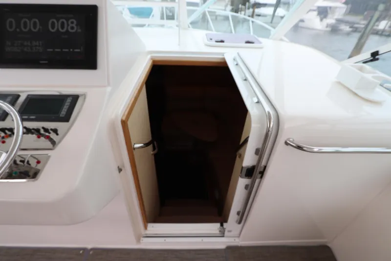 Slide: The Image of 2007 Cabo 40 Hardtop Express cabin entrance with control panel and steering wheel visible. - 36