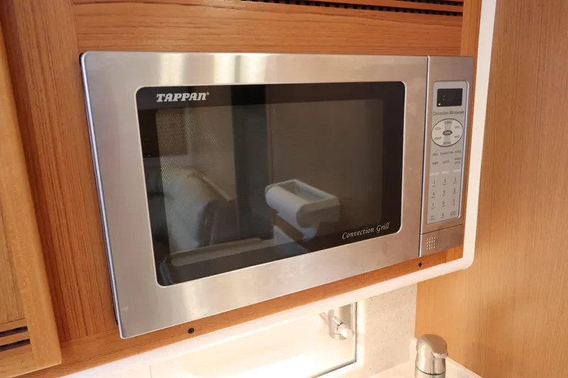 Slide: The Image of Built-in microwave in 2007 Cabo 40 Hardtop Express yacht kitchen. - 43