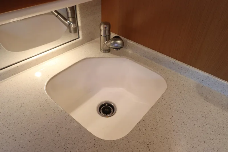 Slide: The Image of White sink with modern faucet on speckled countertop, Cabo 40 Hardtop Express 2007. - 44