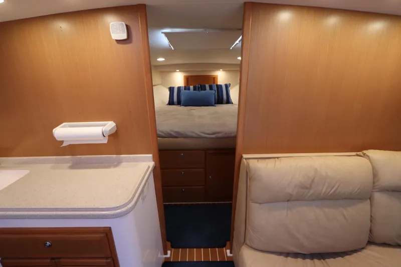 Slide: The Image of Interior of 2007 Cabo 40 Hardtop Express yacht with cozy bedroom and seating area. - 45