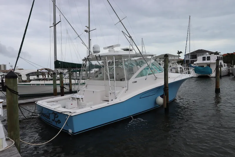 Slide: The Image of 2007 Cabo 40 Hardtop Express boat docked in marina, overcast sky. - 5