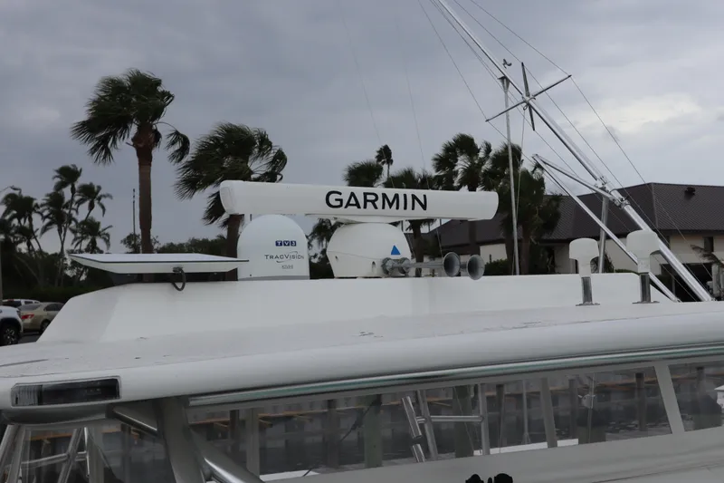 Slide: The Image of 2007 Cabo 40 Hardtop Express with Garmin radar, docked under cloudy skies. - 8