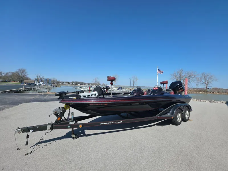 Slide: The Image of 2011 Ranger Z521 Comanche boat on trailer at lakeside with clear blue sky. - 1