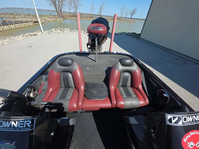 Slide: The Image of 2011 Ranger Z521 Comanche boat with dual seats, docked near a lake. - 10