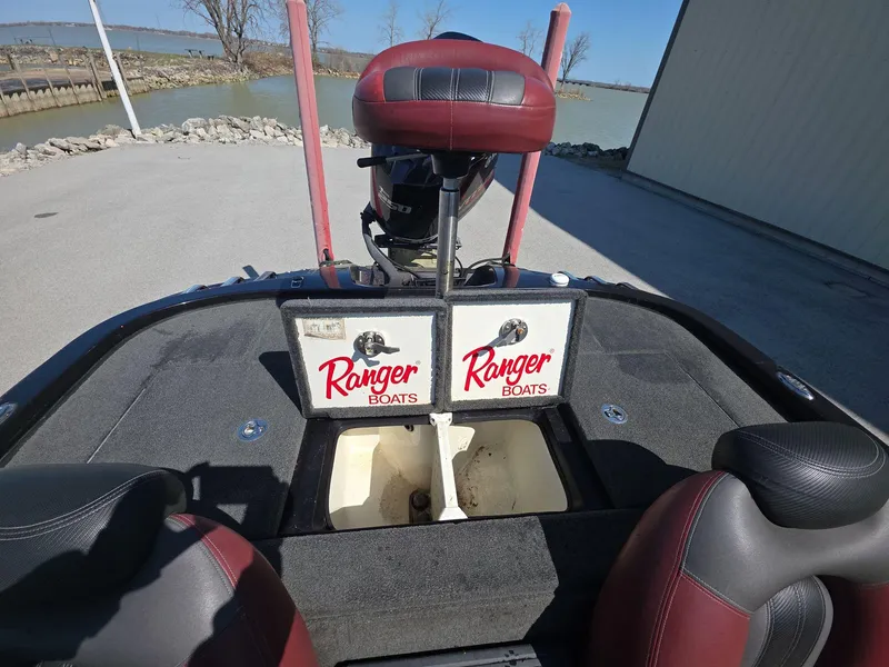 Slide: The Image of 2011 Ranger Z521 Comanche boat interior with red seats and storage compartments. - 13