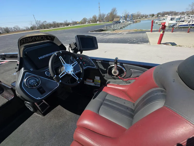 Slide: The Image of 2011 Ranger Z521 Comanche boat interior with steering wheel and dashboard, dockside view. - 6