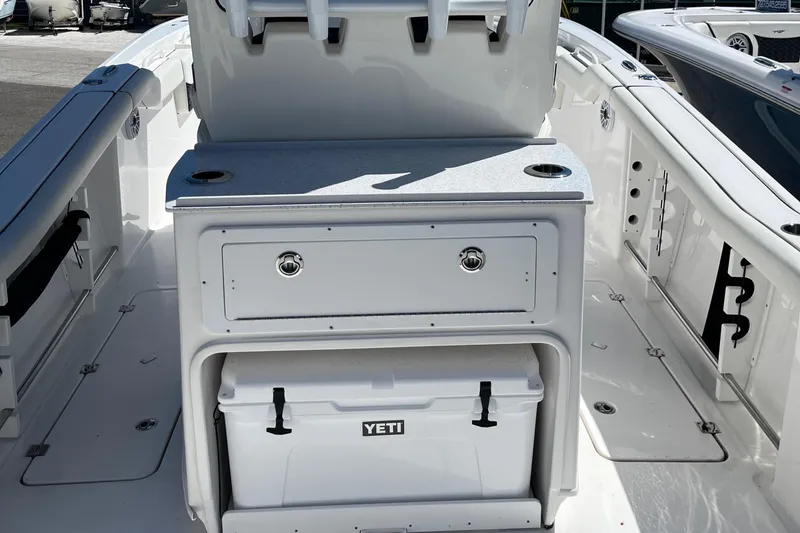 Slide: The Image of 2024 Tidewater 272 CC Adventure boat interior with Yeti cooler and storage. - 10