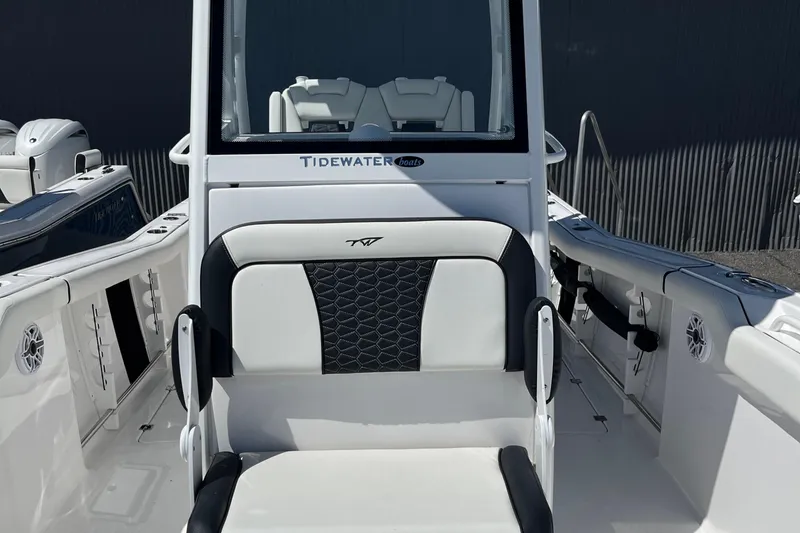 Slide: The Image of 2024 Tidewater 272 CC Adventure boat interior with seating and console details. - 11