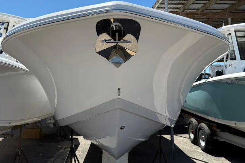 Slide: The Image of 2024 Tidewater 272 CC Adventure boat, front view, displayed on stands. - 14