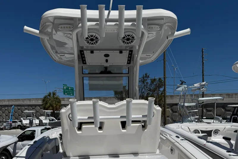 Slide: The Image of 2024 Tidewater 272 CC Adventure boat with rod holders and speakers, viewed from the rear. - 15