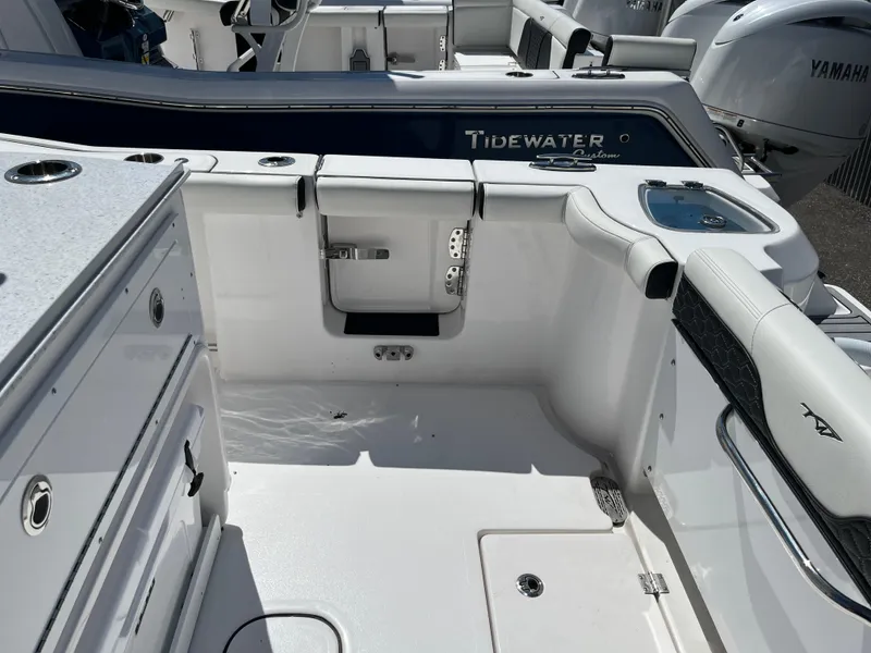 Slide: The Image of 2024 Tidewater 272 CC Adventure boat interior with seating and storage compartments. - 5