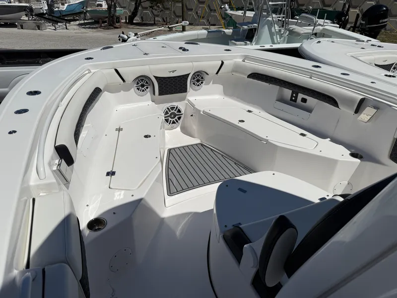 Slide: The Image of 2024 Tidewater 272 CC Adventure boat interior with seating and speakers. - 7