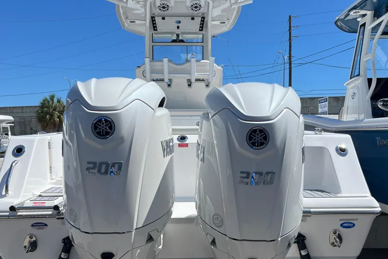 Slide: The Image of 2024 Tidewater 272 CC Adventure boat with dual Yamaha outboard engines. - 9