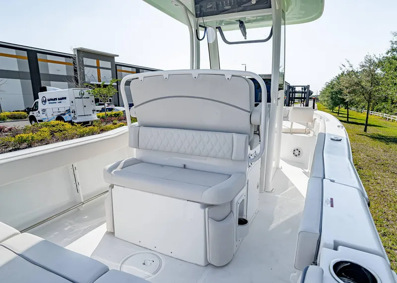 Slide: The Image of 2025 Sea Hunt Ultra 245 SE boat interior with white seating and console. - 10
