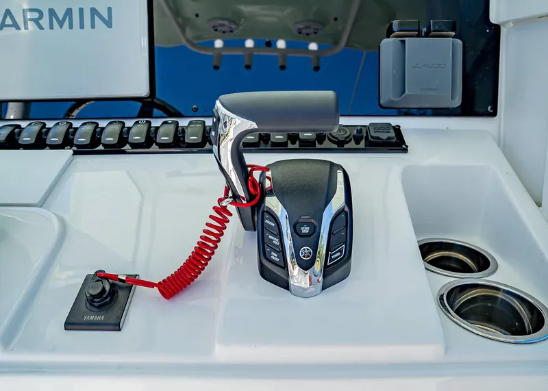 Slide: The Image of 2025 Sea Hunt Ultra 245 SE boat control panel with Yamaha throttle and Garmin display. - 21