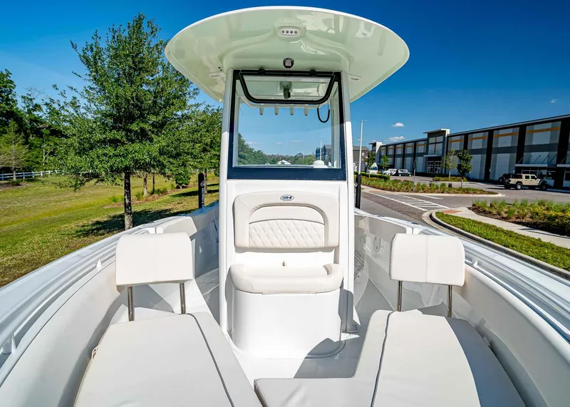 Slide: The Image of 2025 Sea Hunt Ultra 245 SE boat with white seating and modern design. - 23