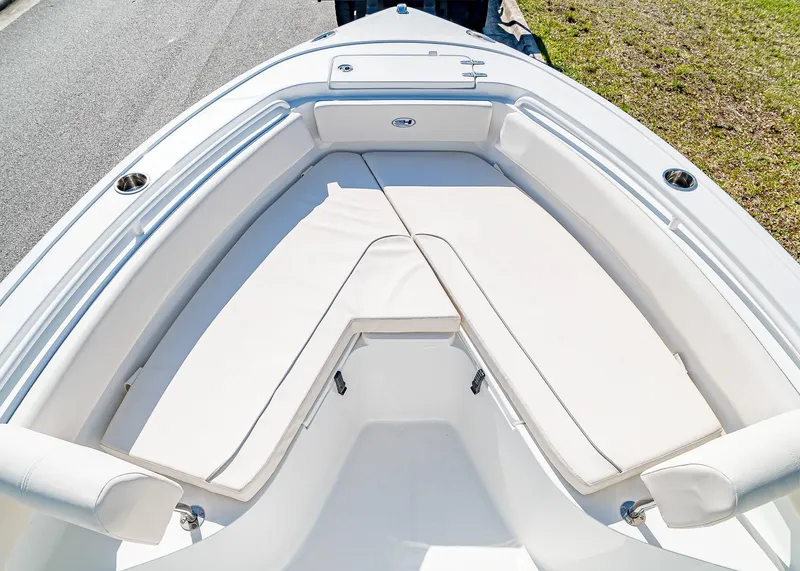 Slide: The Image of 2025 Sea Hunt Ultra 245 SE boat with spacious white seating area. - 25