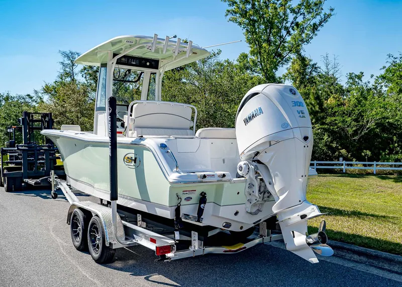 Slide: The Image of 2025 Sea Hunt Ultra 245 SE boat on trailer with Yamaha 300 V6 engine. - 5