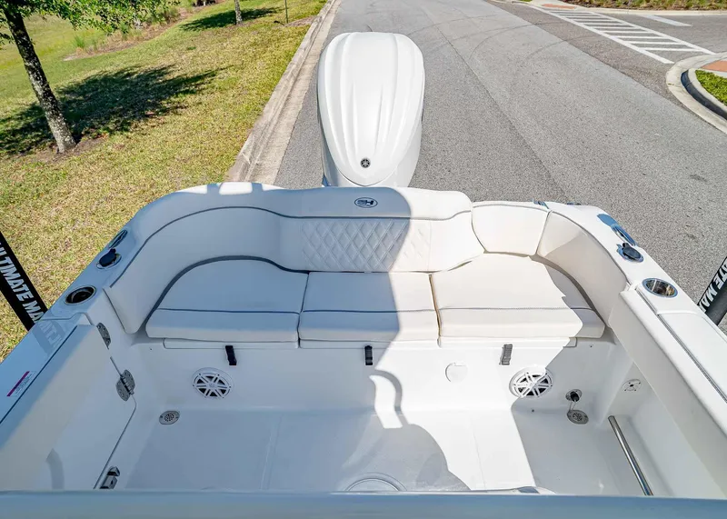 Slide: The Image of 2025 Sea Hunt Ultra 245 SE boat interior with white seating and speakers. - 8