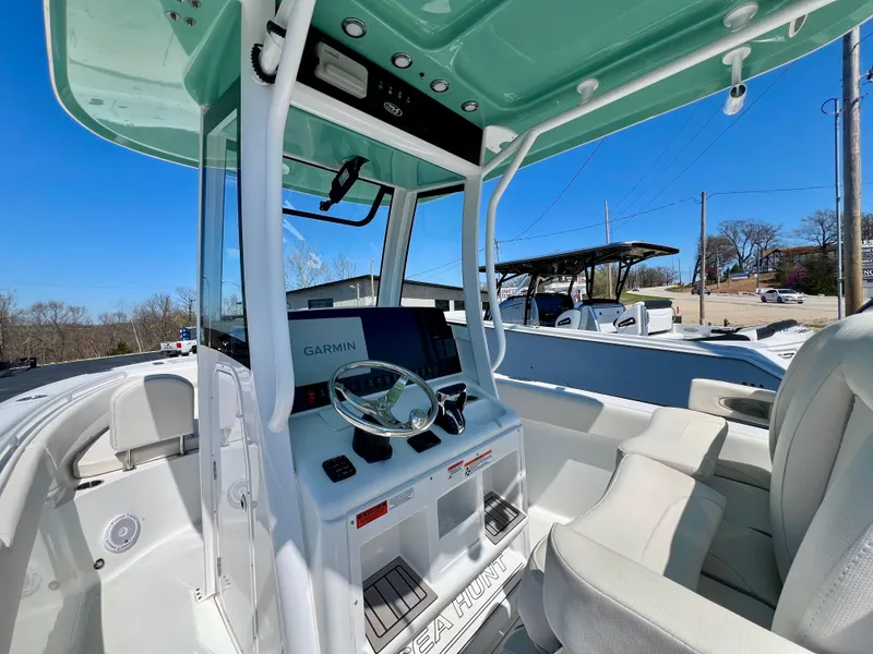 Slide: The Image of 2023 Sea Hunt Ultra 265 SE boat interior with modern helm and seating. - 10