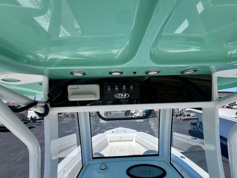 Slide: The Image of 2023 Sea Hunt Ultra 265 SE boat interior with control panel and seating view. - 11