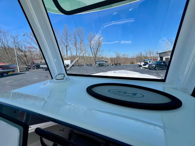 Slide: The Image of 2023 Sea Hunt Ultra 265 SE boat dashboard with clear windshield view. - 12