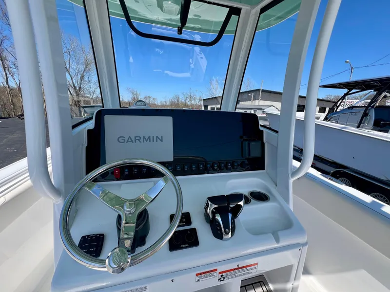 Slide: The Image of 2023 Sea Hunt Ultra 265 SE boat dashboard with Garmin navigation system. - 13