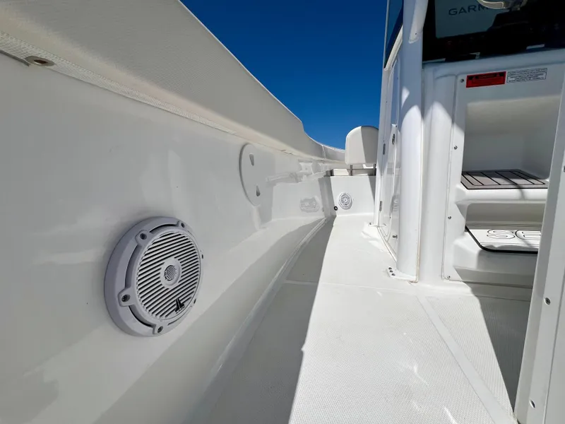 Slide: The Image of 2023 Sea Hunt Ultra 265 SE boat interior with speaker, white deck, and storage compartment. - 18