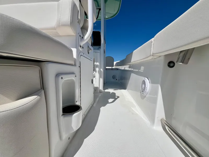 Slide: The Image of 2023 Sea Hunt Ultra 265 SE boat interior with white seating and storage compartments. - 19