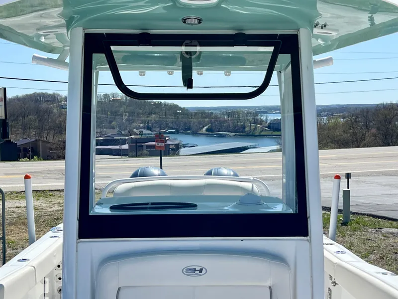 Slide: The Image of 2023 Sea Hunt Ultra 265 SE boat with scenic waterfront view in the background. - 22