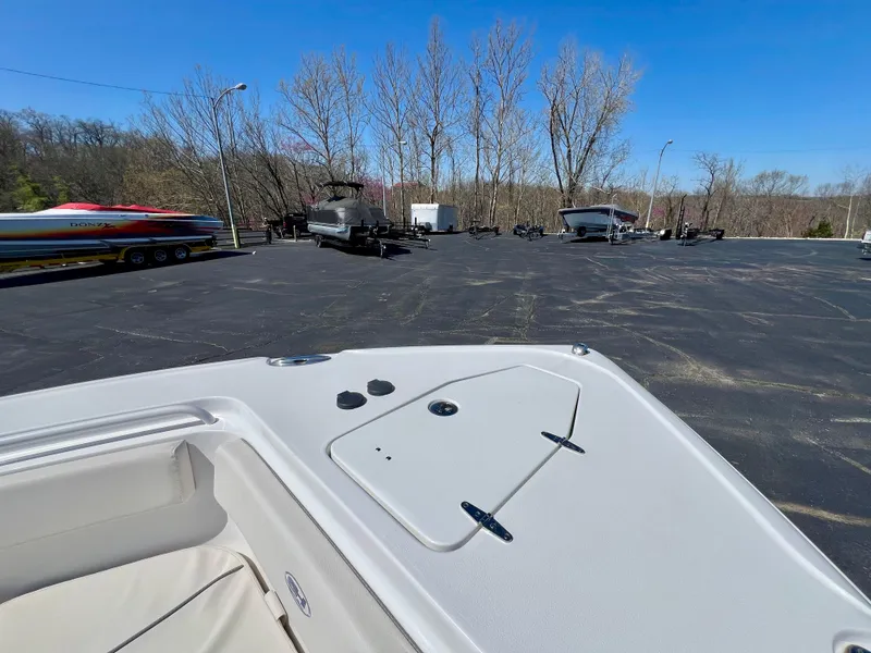 Slide: The Image of 2023 Sea Hunt Ultra 265 SE boat parked in a lot with other boats. - 25