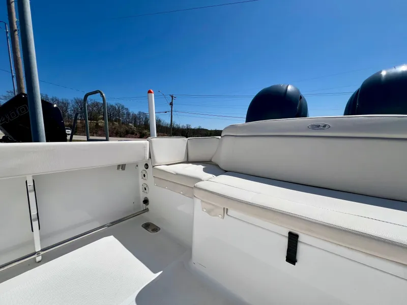 Slide: The Image of 2023 Sea Hunt Ultra 265 SE boat interior with seating and dual engines. - 7