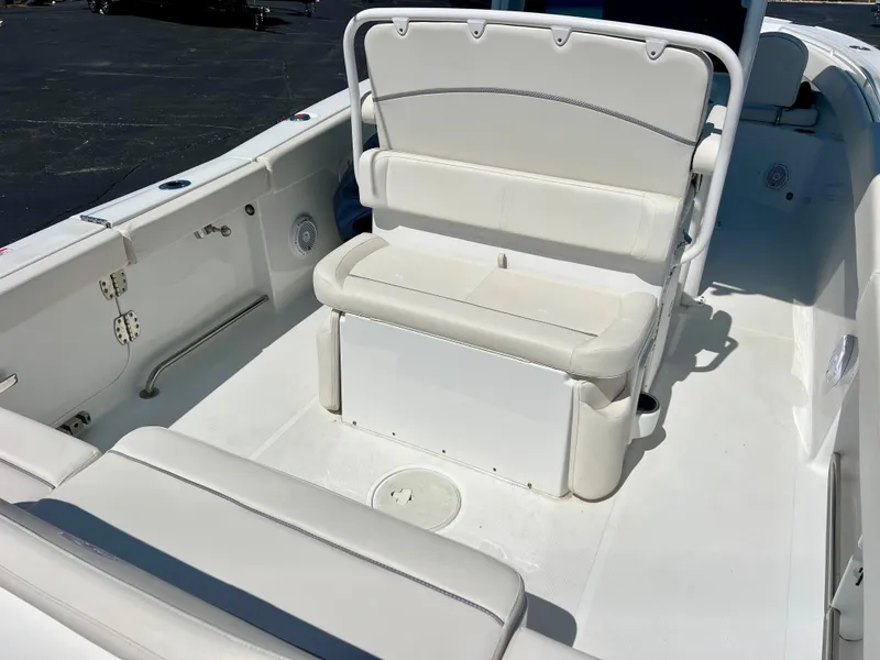 Slide: The Image of 2023 Sea Hunt Ultra 265 SE boat interior with white seating and storage. - 9