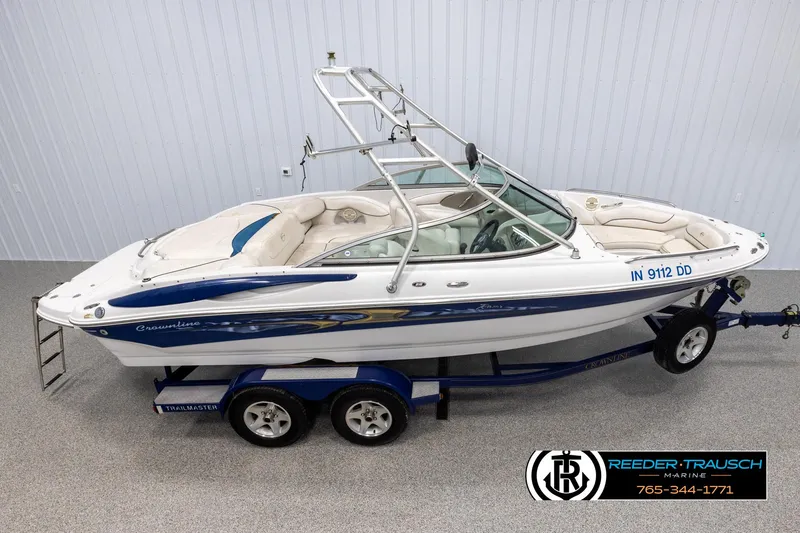 Slide: The Image of 2005 Crownline 216 LS boat on trailer in showroom setting. - 1