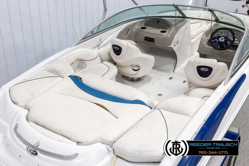 Slide: The Image of 2005 Crownline 216 LS boat interior with white seating and dashboard. - 11