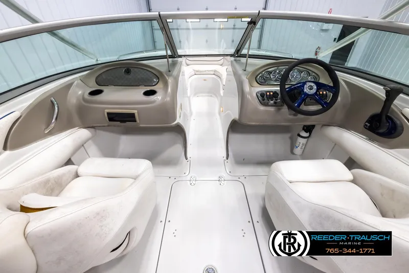 Slide: The Image of 2005 Crownline 216 LS boat interior with steering wheel and seating. - 13
