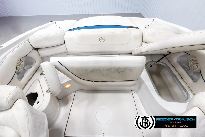 Slide: The Image of 2005 Crownline 216 LS boat interior with white seating and storage compartments. - 20