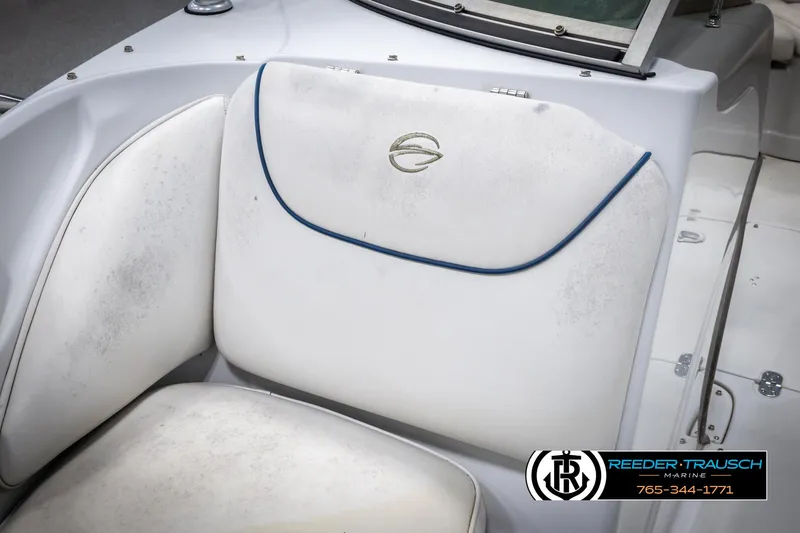 Slide: The Image of 2005 Crownline 216 LS boat seat with logo, white upholstery, and blue trim. - 21