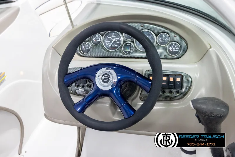 Slide: The Image of 2005 Crownline 216 LS boat dashboard with steering wheel and instrument panel. - 23