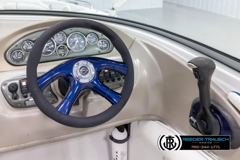 Slide: The Image of Steering wheel and dashboard of a 2005 Crownline 216 LS boat. - 24