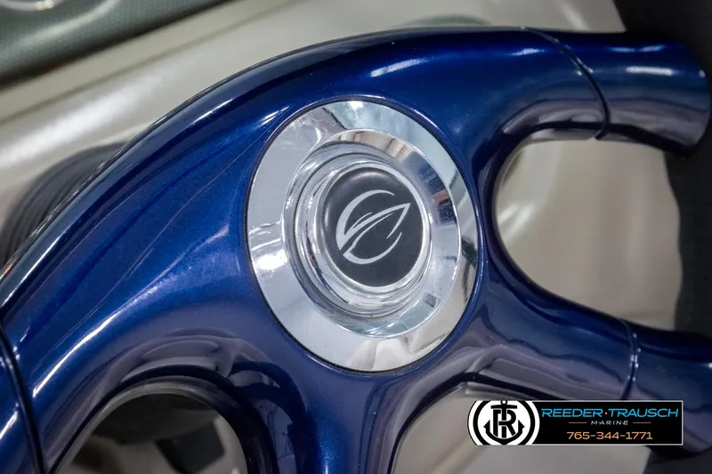 Slide: The Image of Steering wheel of 2005 Crownline 216 LS boat, featuring a sleek blue design. - 25